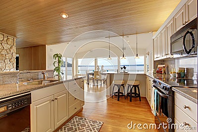Kitchen area with paneled ceiling and hardwood floor Stock Photo