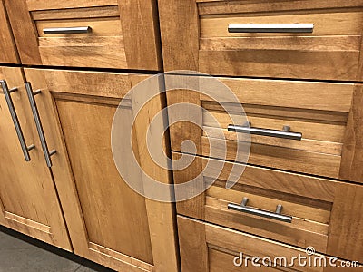 Kitchen cabinets made of natural wood maple with chrome handles Stock Photo