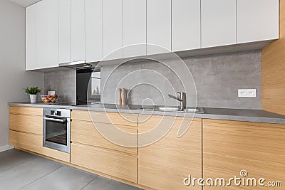 Kitchen with concrete worktop and wooden furniture Stock Photo