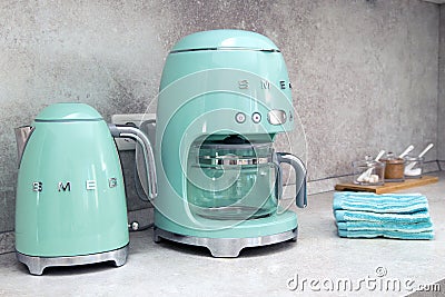 On kitchen counter top closeup in row SMEG brank kitchen appliances for easy life, coffee maker electric teapot , popular Italian Editorial Stock Photo