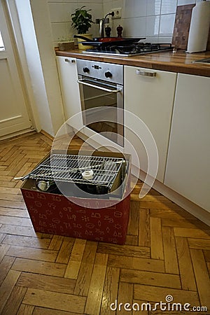 Kitchen with deal crate wooden parquet and table with flowers and home appliances Stock Photo