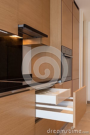 Kitchen detail with stove, hood and open drawers Stock Photo