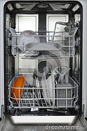 Kitchen dishwasher with dirty dishes inside ready to wash Stock Photo