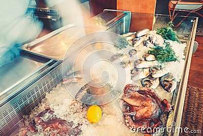 Kitchen fresh frozen seafood: fish, octopus with herbs and lemon on ice. Ingredients for delicacies Stock Photo