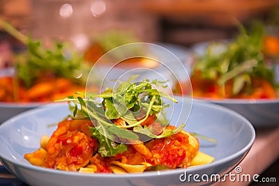 Cooking pasta, sumptuous dinner, Italian tomato seafood noodles, Stock Photo