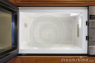 Kitchen home electric appliances interior inside view of open, empty, clean microwave oven Stock Photo