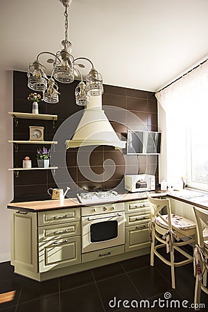 Kitchen interior in bright colors stove refrigerator chairs Stock Photo