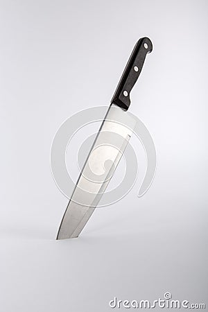 Kitchen knife embedded in surface Stock Photo