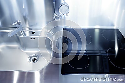 Kitchen silver sink and vitroceramic stove hob Stock Photo
