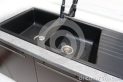 Kitchen sink with the mixer tap Stock Photo