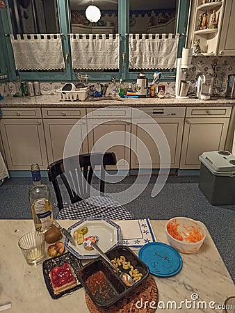 Kitchen table with dinner leftovers eaten by a lonely person during the coronavirus lookdown Editorial Stock Photo