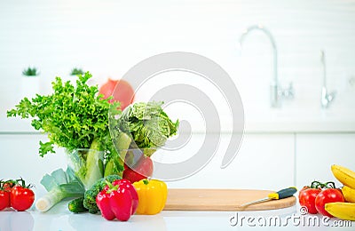 Kitchen table with fresh organic vegetables and fruits Stock Photo