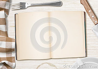 Kitchen table with open book or copybook for cooking recipe Stock Photo