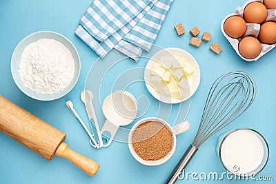 Kitchen utensils and baking ingredients on blue background Stock Photo