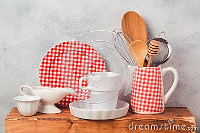 Kitchen utensils and dishware on wooden board Stock Photo