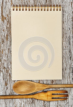 Kitchen utensils and paper spiral notebook on the old wood Stock Photo