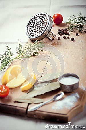 Kitchen utensils, spices and herbs cooking fish Stock Photo