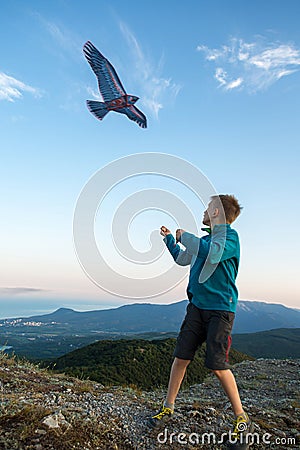 Kite flying. The boy launches a kite. Beautiful sunset Stock Photo