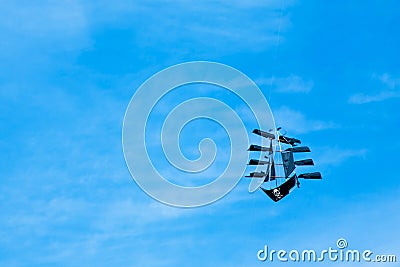 Kite like ship with jolly roger flying on the blue sky Stock Photo