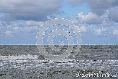 Kite surfer enjoys a brisk wind on the Baltic seashore in Pavilosta Stock Photo