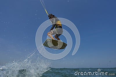 Kite surfer rjumps with kiteboard Stock Photo