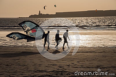 Kite surfers returning from the sea as the sun sets Editorial Stock Photo