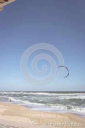 Kite surfing on the beach. Active lifestyle. Extreme sports concept. Man in wetsuit with kite board at seaside Stock Photo