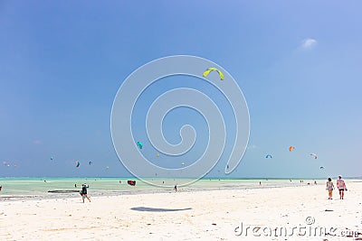Kite surfing on tropical beach, low tide. Kite surfers on the sea. Scenic Indian Ocean with kite boards, Zanzibar, Paje beach. Editorial Stock Photo