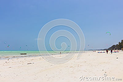 Kite surfing on tropical beach, low tide. Kite surfers on the sea. Scenic Indian Ocean with kite boards, Zanzibar, Paje beach. Editorial Stock Photo