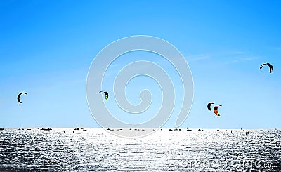 Kiteboarding. Kite surfing against a beautiful blue sky. Many silhouettes of kites in the sky Stock Photo