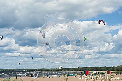 Kiters on the bay on a sunny windy day. People at the beach. Summer sport. Summer lifestyle. Stock Photo