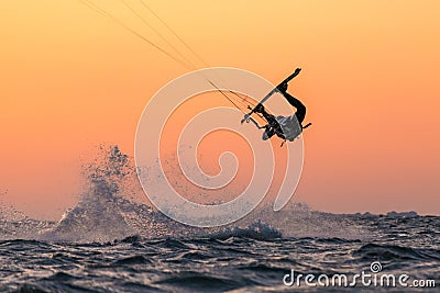 Kitesurfer doing unhooked tricks in sunset conditions and nice colors Editorial Stock Photo