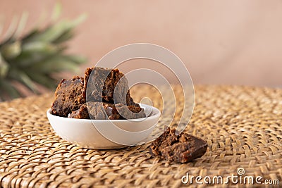Kithul jaggery and treacle natural sweetener in white bowl. Alternative sugar and superfood. Stock Photo