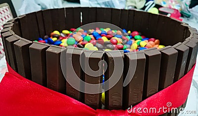 Kitkat chocolate cake with pebbles.Kit Kat broken chocolate bar. Kit Kat is a chocolate biscuit bar. Bar, biscuit, break.With Editorial Stock Photo