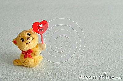 A kitten figurine holding a red heart Stock Photo