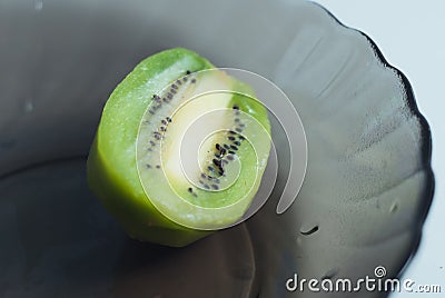 KIWI fruit on black plate, sliced , Stock Photo