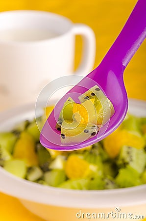 Spoonful of fruit as part of child`s diet Stock Photo