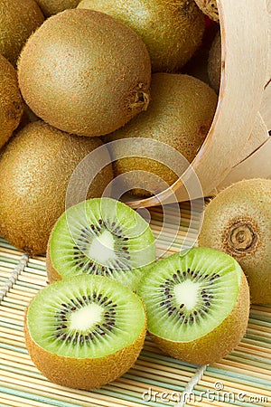 Kiwi sliced and whole fruits, basket Stock Photo