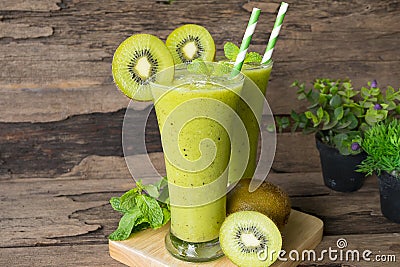 Kiwi yogurt smoothies juice and kiwi green fruit for breakfast in the morning on wood background. Stock Photo