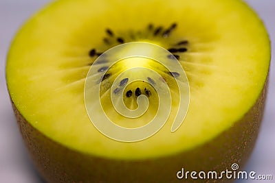 Close up of half cutted kiwifruits from New Zealand. Background of fresh and juicy golden green kiwis for healthy smoothies Stock Photo