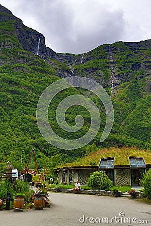 Kjelfossen waterfalls grass roof house Gudvangen Norway Editorial Stock Photo