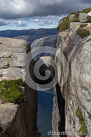 The famous boulder Kjeragbolten that is wedged in a mountain crevasse, Norway Stock Photo