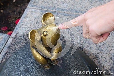 KLAIPEDA, LITHUANIA - SEPTEMBER 22, 2018: Sculpture known as Wonderful Little Mouse and human hand. Editorial Stock Photo