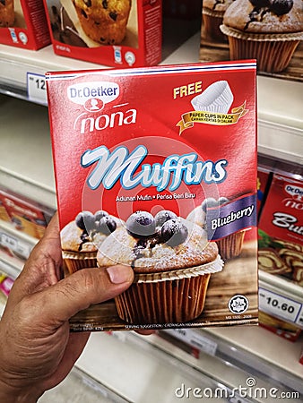 KLANG, MALAYSIA - 12 September 2020 : Hand hold a boxed of Dr Oetker Muffins Blueberry flour for sell in the supermarket. Editorial Stock Photo
