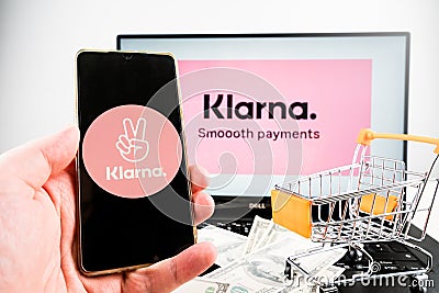 Klarna smooth payments logo on laptop and klarna company app logo on mobile phone. Editorial Stock Photo