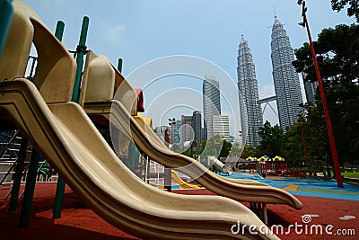 KLCC Park playground and Petronas Twin Towers. Kuala Lumpur. Malaysia Editorial Stock Photo
