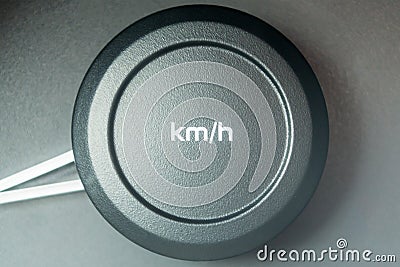 kmh lettering on a round plastic button. Car speedometer. Stock Photo