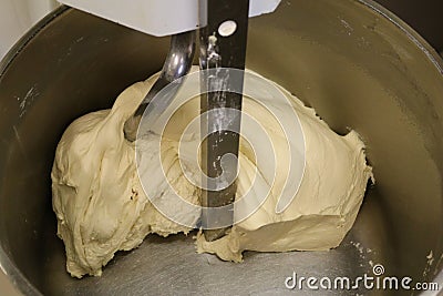 Kneading dough. Mixing dough kneading machine. Pizza dough. Stock Photo