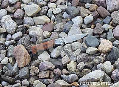 Knife in the background of small stones Stock Photo