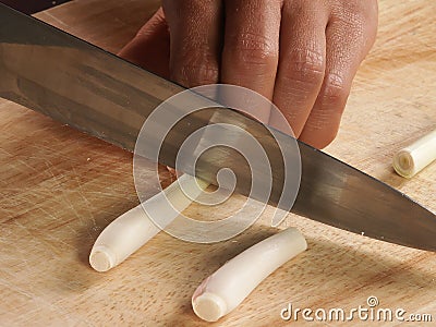 Knife cut lemon glass on chopping board Stock Photo